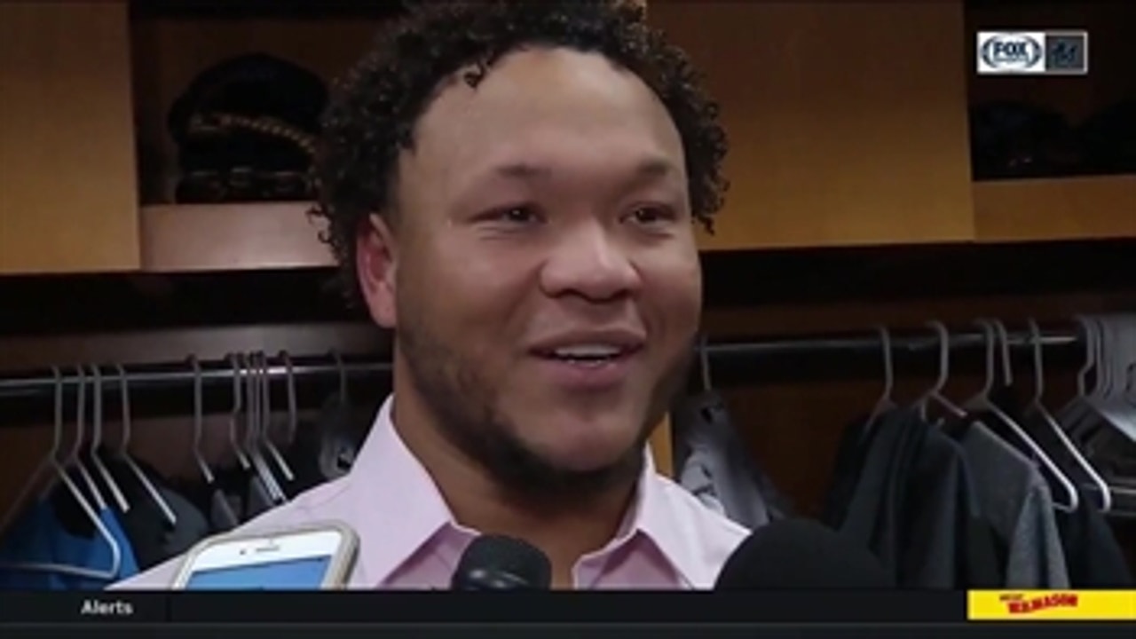 Harold Ramirez reacts to his first career home run, giving the ball to his mother