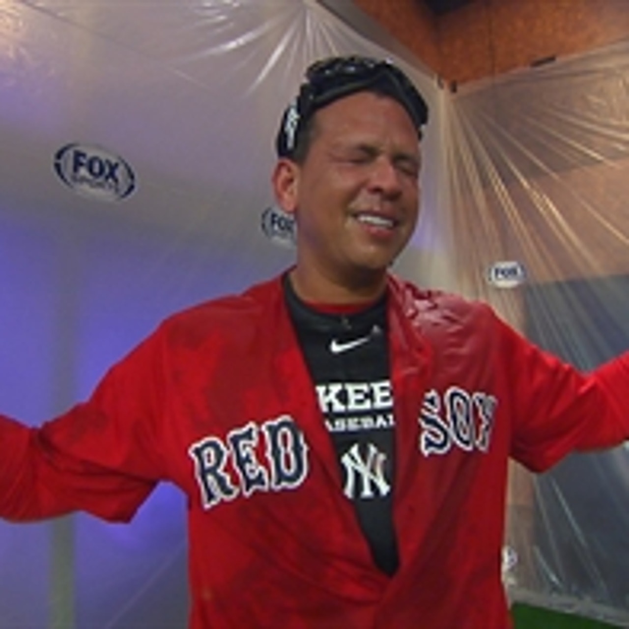 David Ortiz gives Alex Rodriguez a champagne shower while wearing a Red Sox  jersey