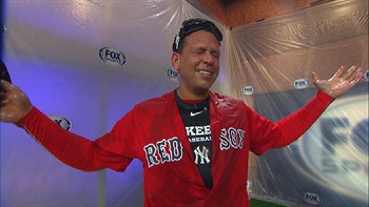 David Ortiz gives Alex Rodriguez a champagne shower while wearing a Red Sox jersey
