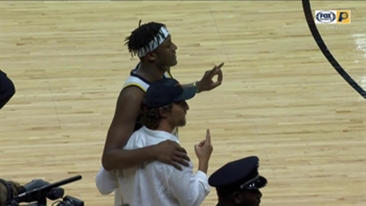 Myles Turner and Matthew McConaughey throw up the Hook 'em Horns after Pacers win