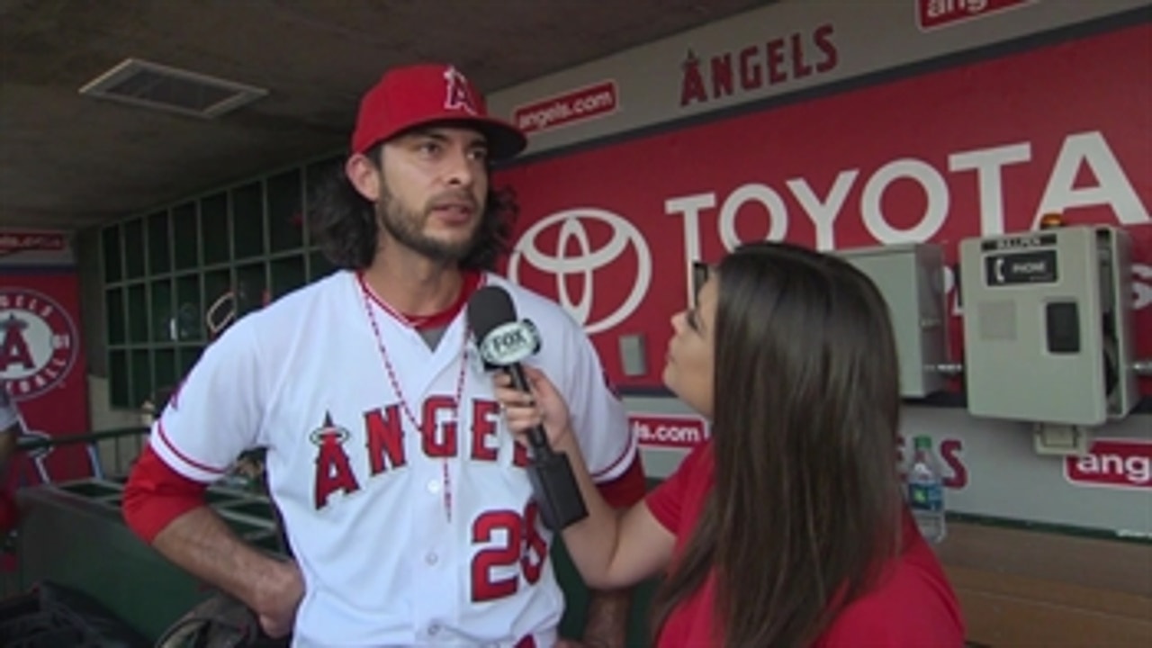 Noe Ramirez talks with Alex Curry after a strong outing on the mound against the Tigers