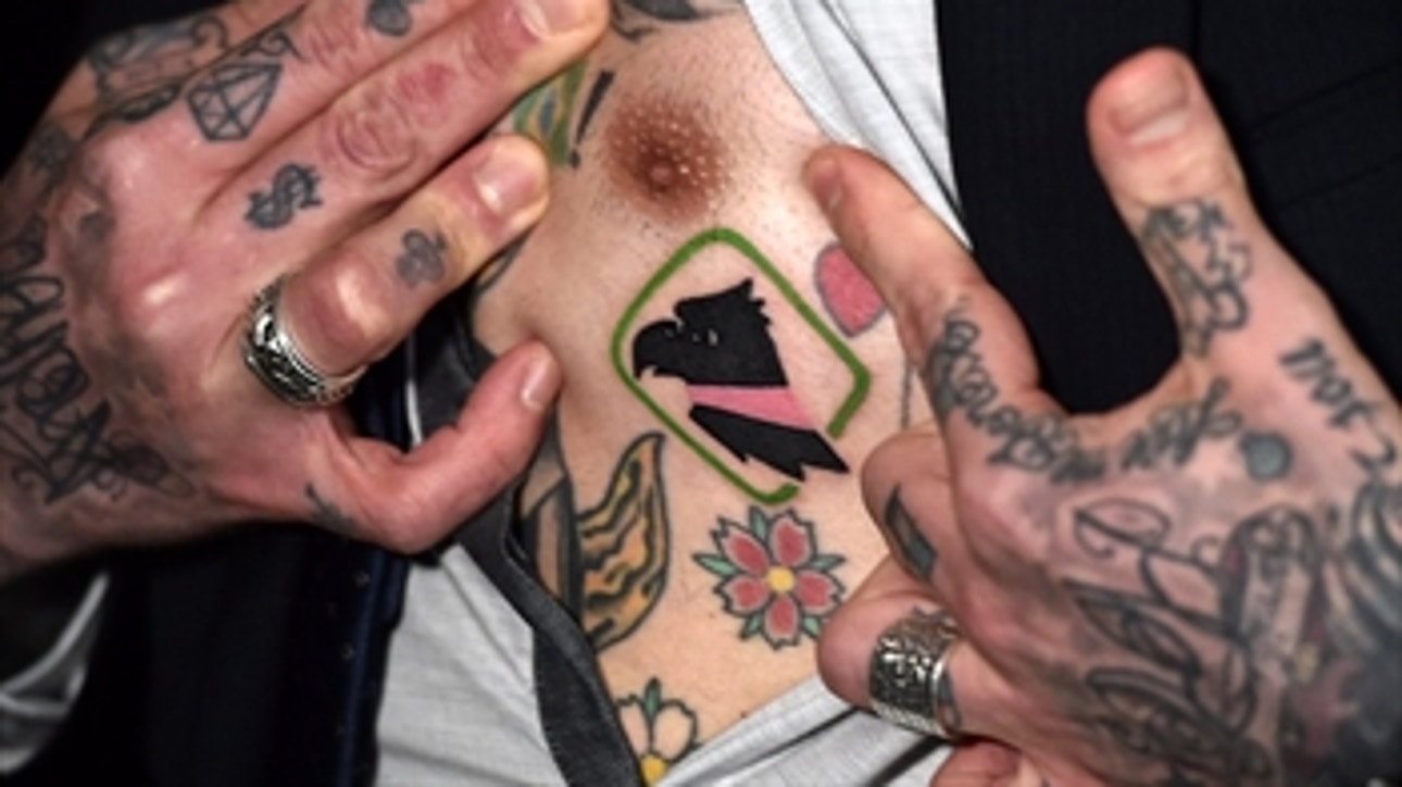 New Palermo owner pops nipple out at a press conference to show off Tattoo
