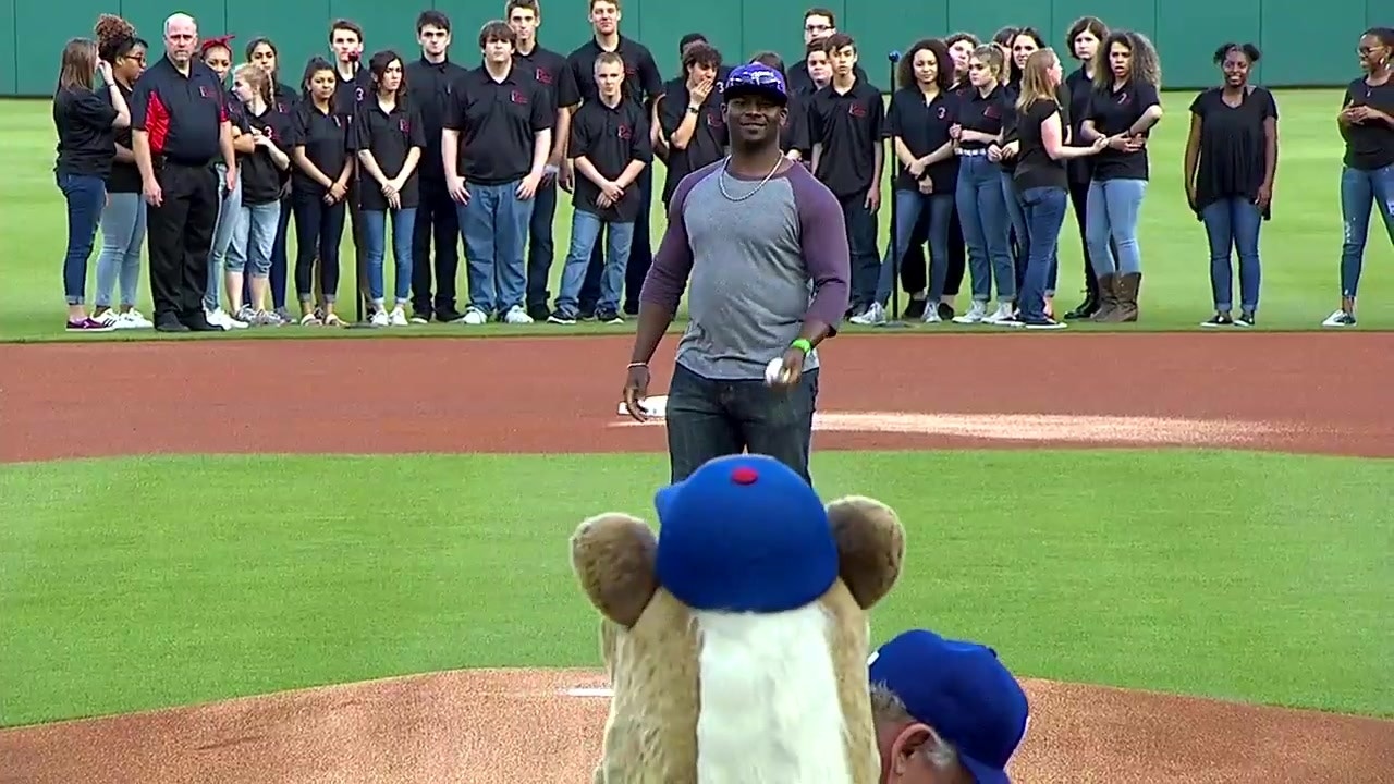 Former TCU running back Ladanian Tomlinson throws out the first pitch