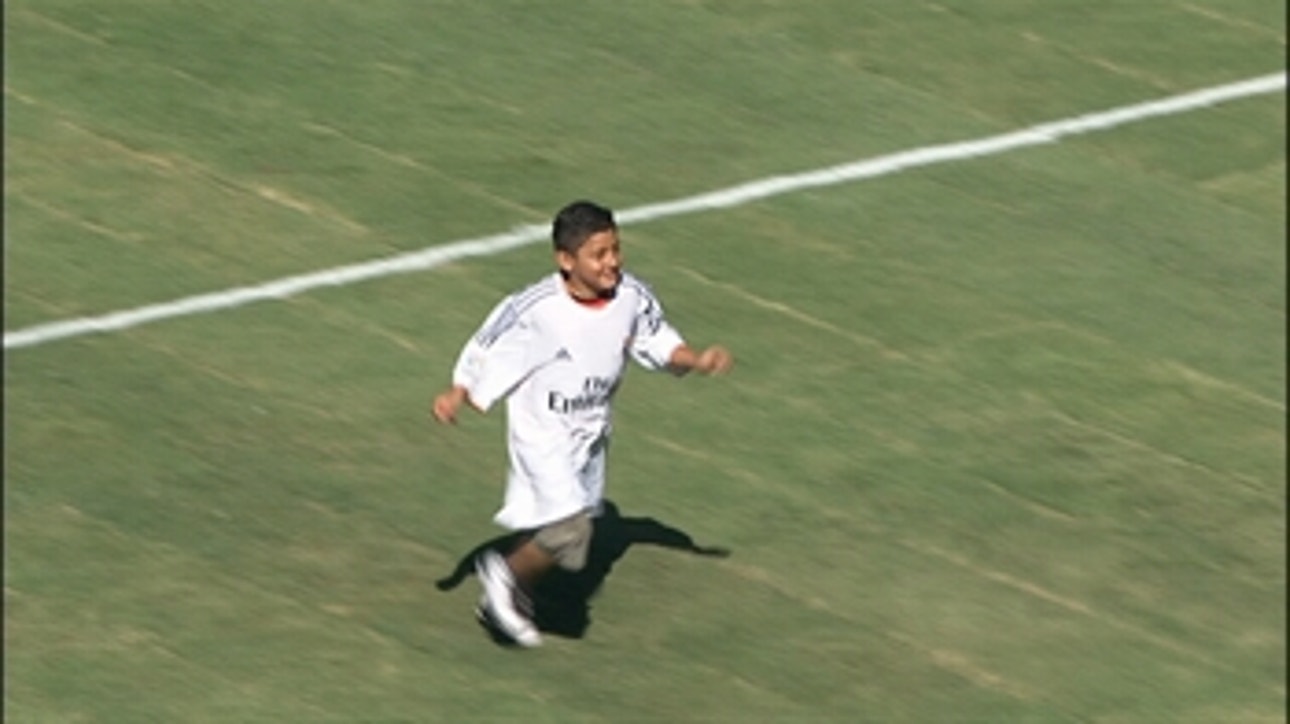 Kid with jersey three times his size, invades pitch