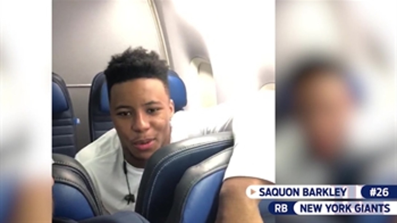 Saquon Barkley and Will Hernandez celebrate their win over the Texans on the team plane