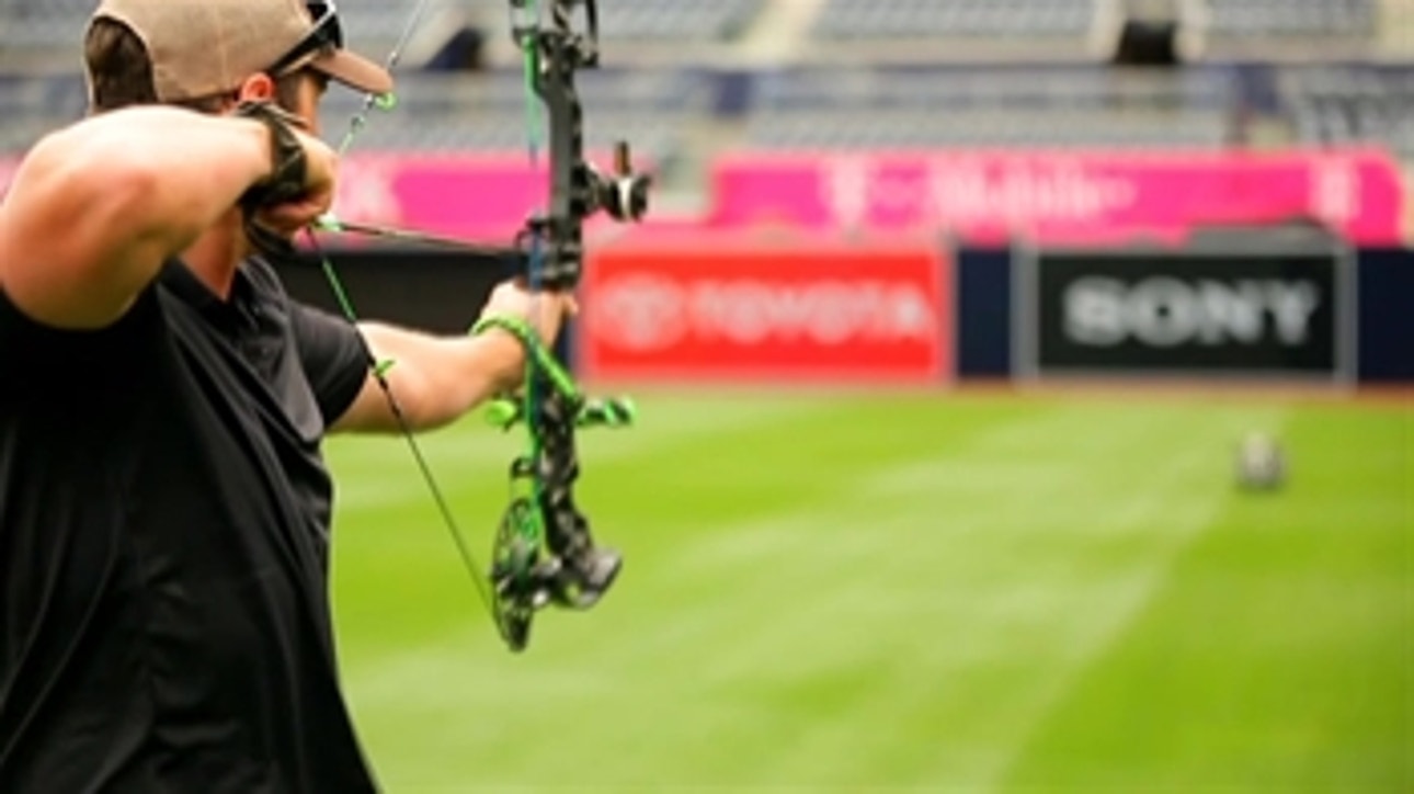Hunter Renfroe shows off his bow and arrow skills