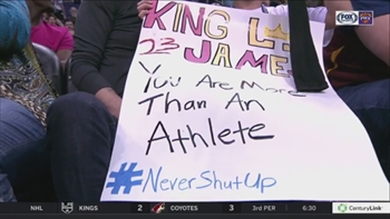 LeBron James gives armband to young fan with #NeverShutUp sign