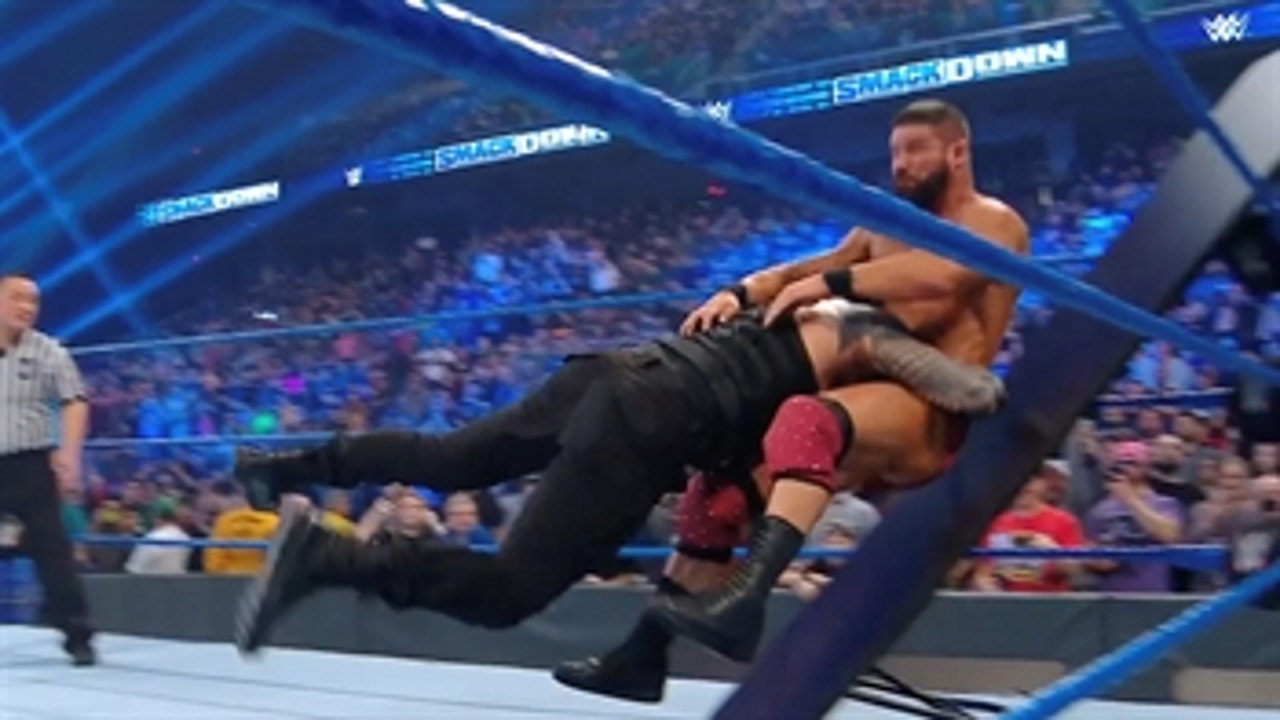 Roman Reigns takes out Bobby Roode in a tables match with help from the Usos
