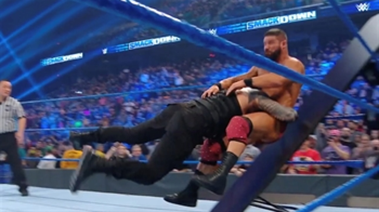 Roman Reigns takes out Bobby Roode in a tables match with help from the Usos