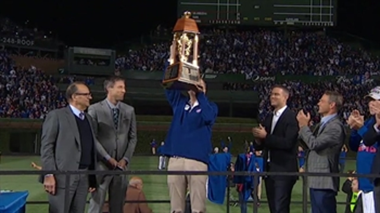 Tom Ricketts accepts the Warren C. Giles Trophy after the Cubs triumph in the NLCS