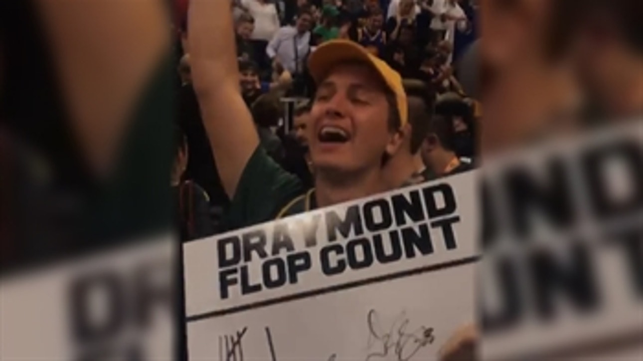 Draymond Green autographs a poster that trolls him