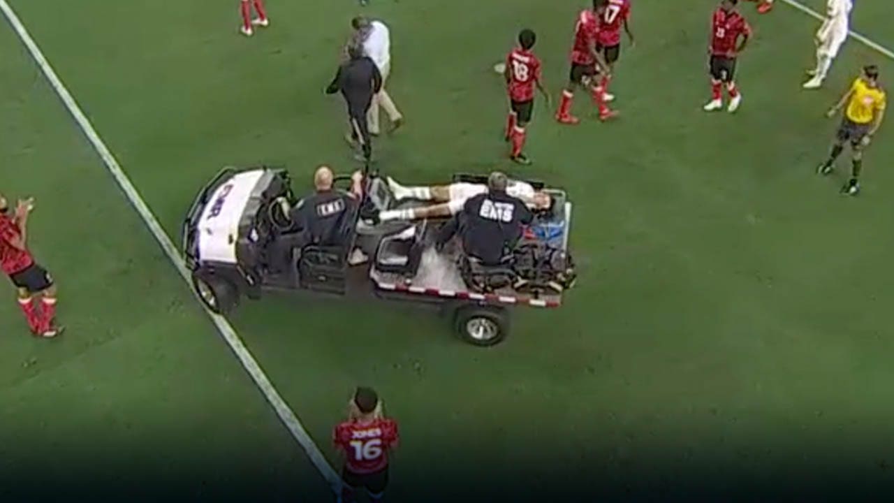 Chucky Lozano is carted off the field after terrifying collision with Trinidad & Tobago goalkeeper