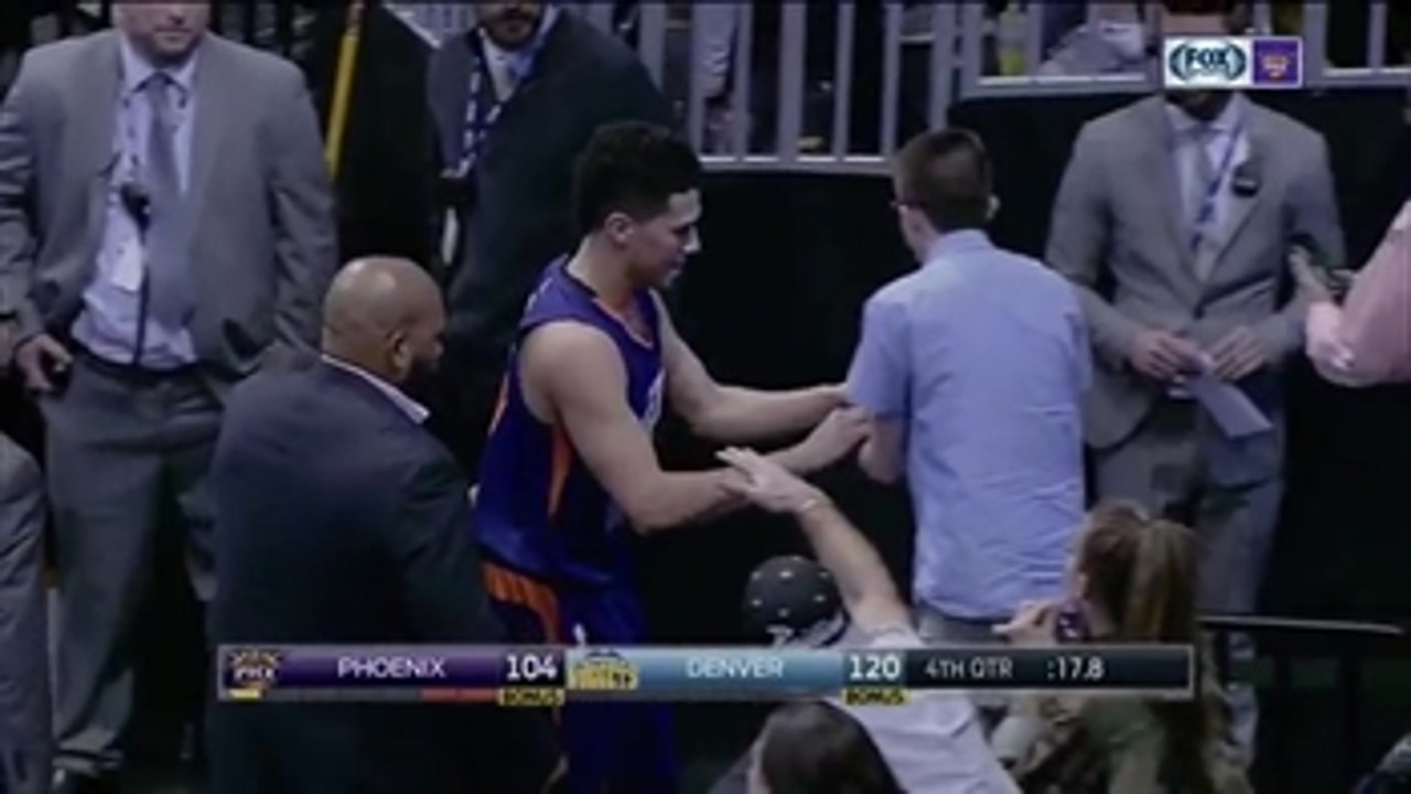 Devin Booker signs autograph after being ejected
