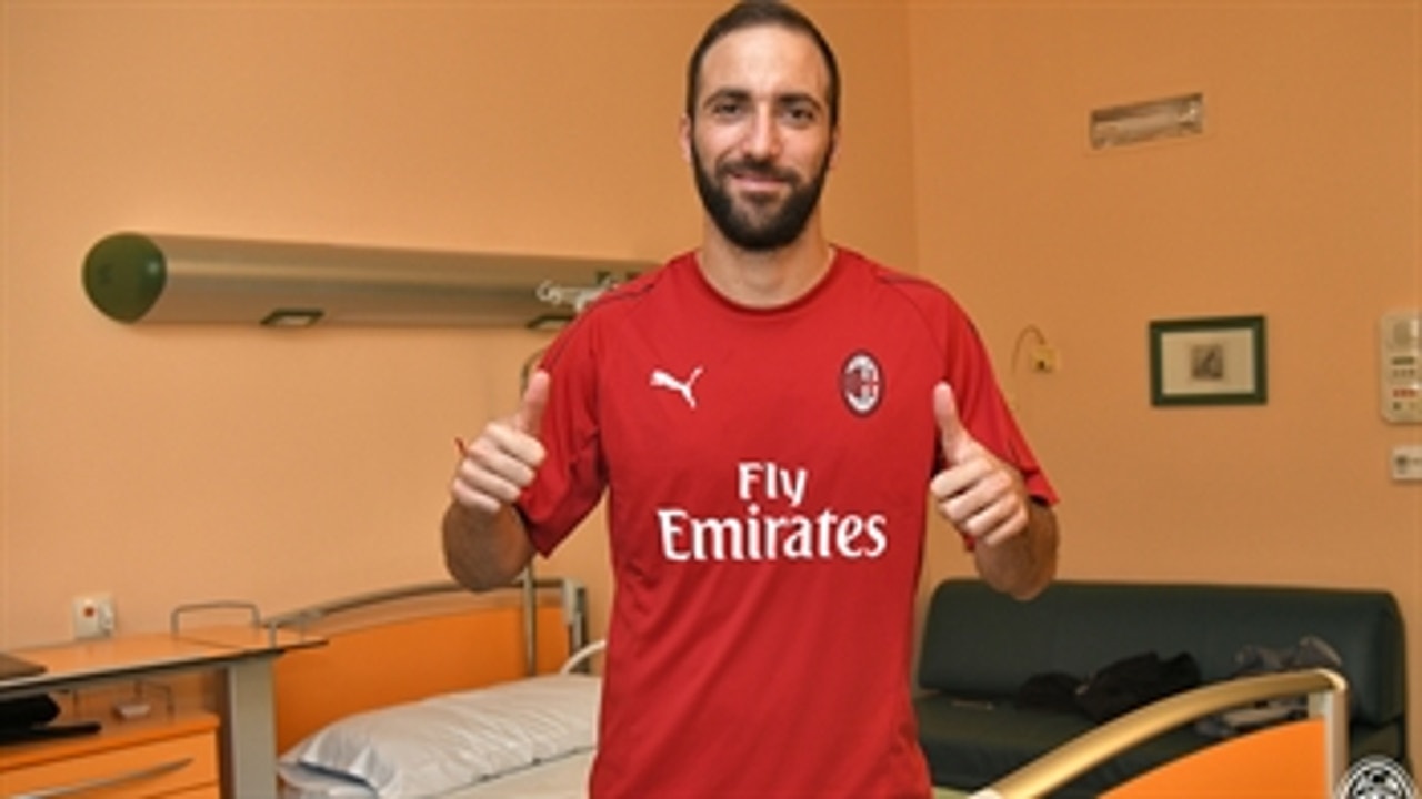 Gonzalo Higuain mobbed by AC Milan fans as he completes loan move