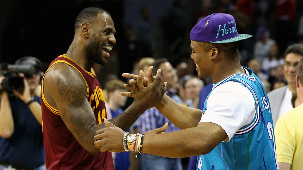 LeBron James and Cam Newton chat at center court