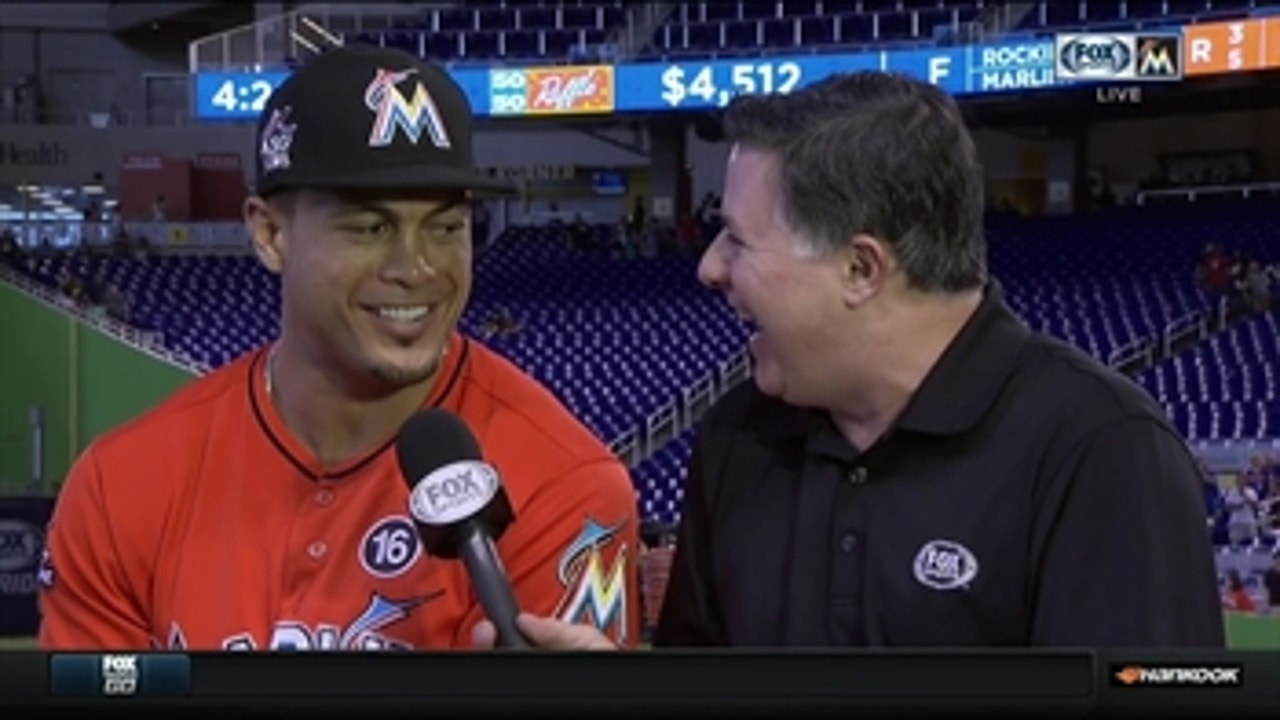 Giancarlo Stanton reacts to tying the club record for home runs in a season