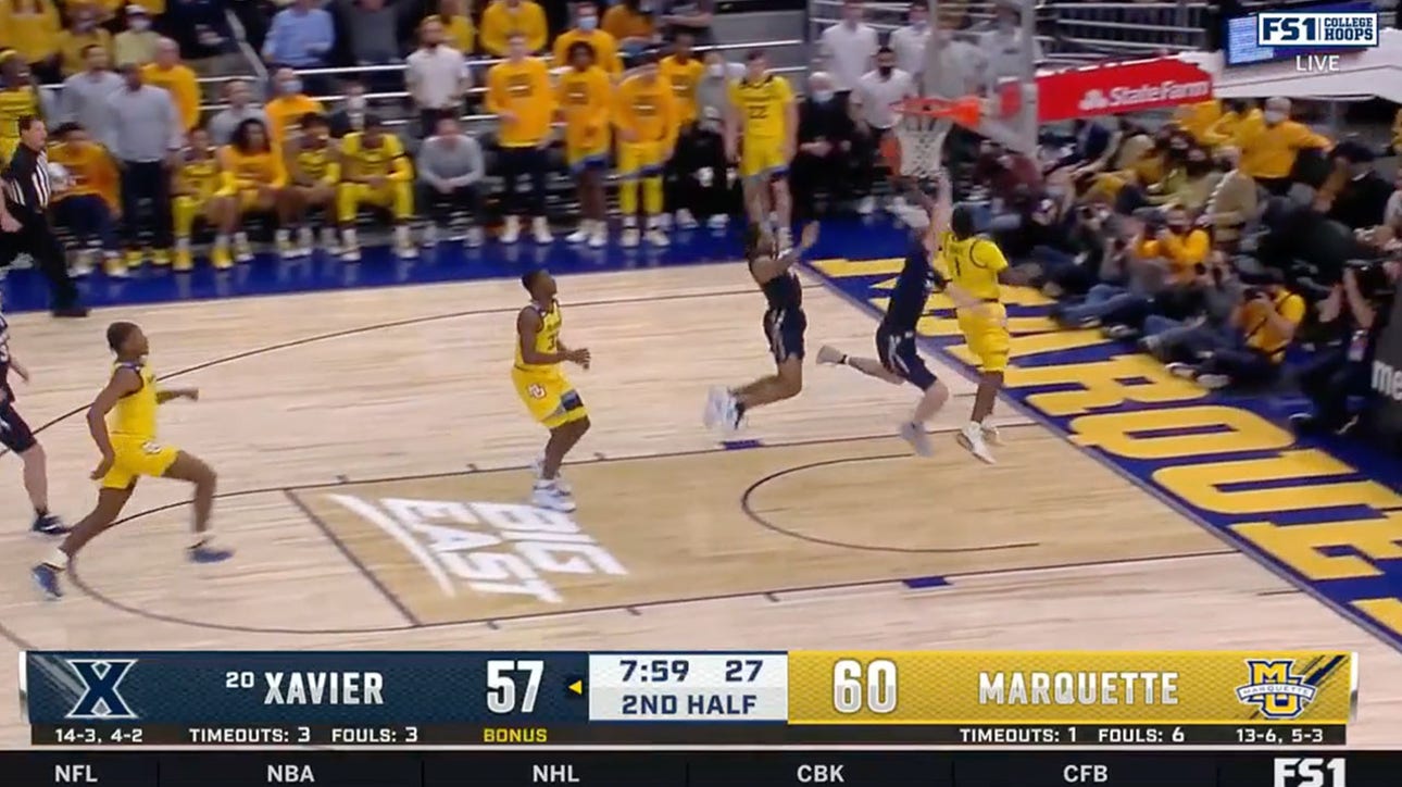 Marquette's Kam Jones with the acrobatic up and under lay-up