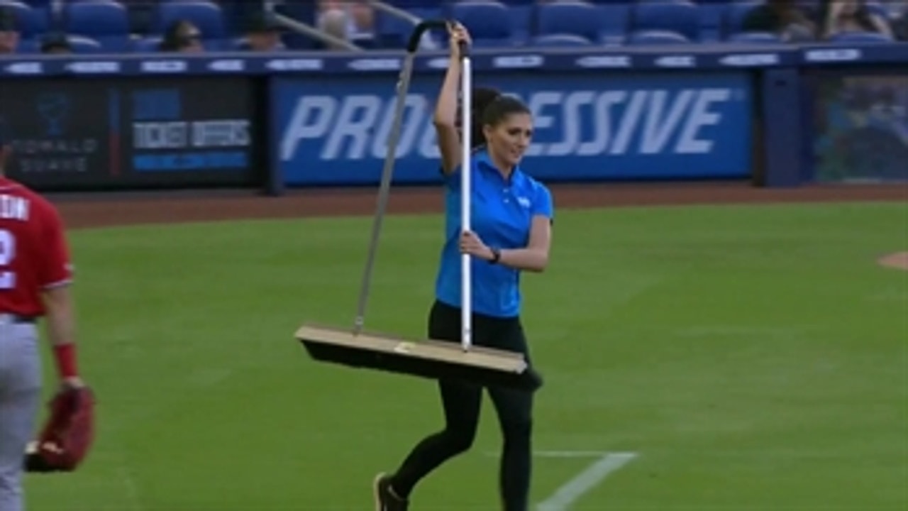 Kelly Saco lends a helping hand to the Marlins grounds crew