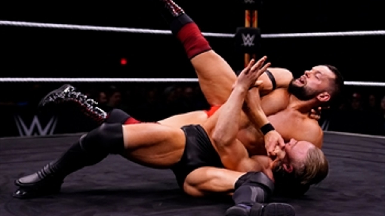 Finn Bálor and Ilja Dragunov trade strikes in the center of the ring: WWE Worlds Collide, Jan. 25, 2020