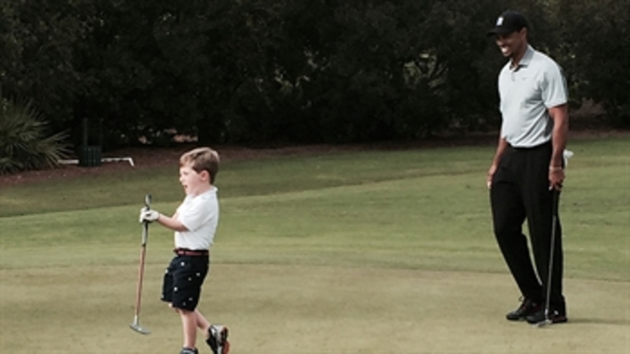 Tiger Woods inspires child, plays golf with him