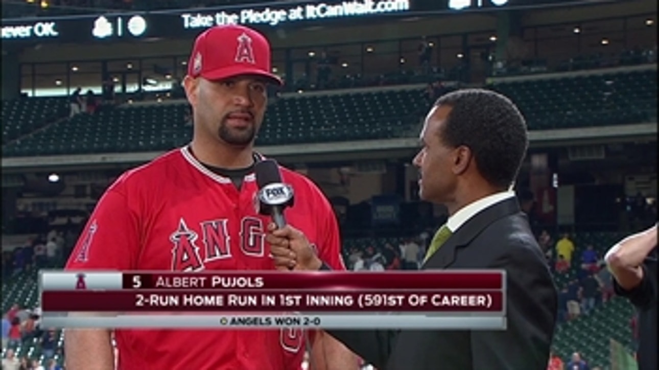 Albert Pujols with Jose Mota after Angels down Astros