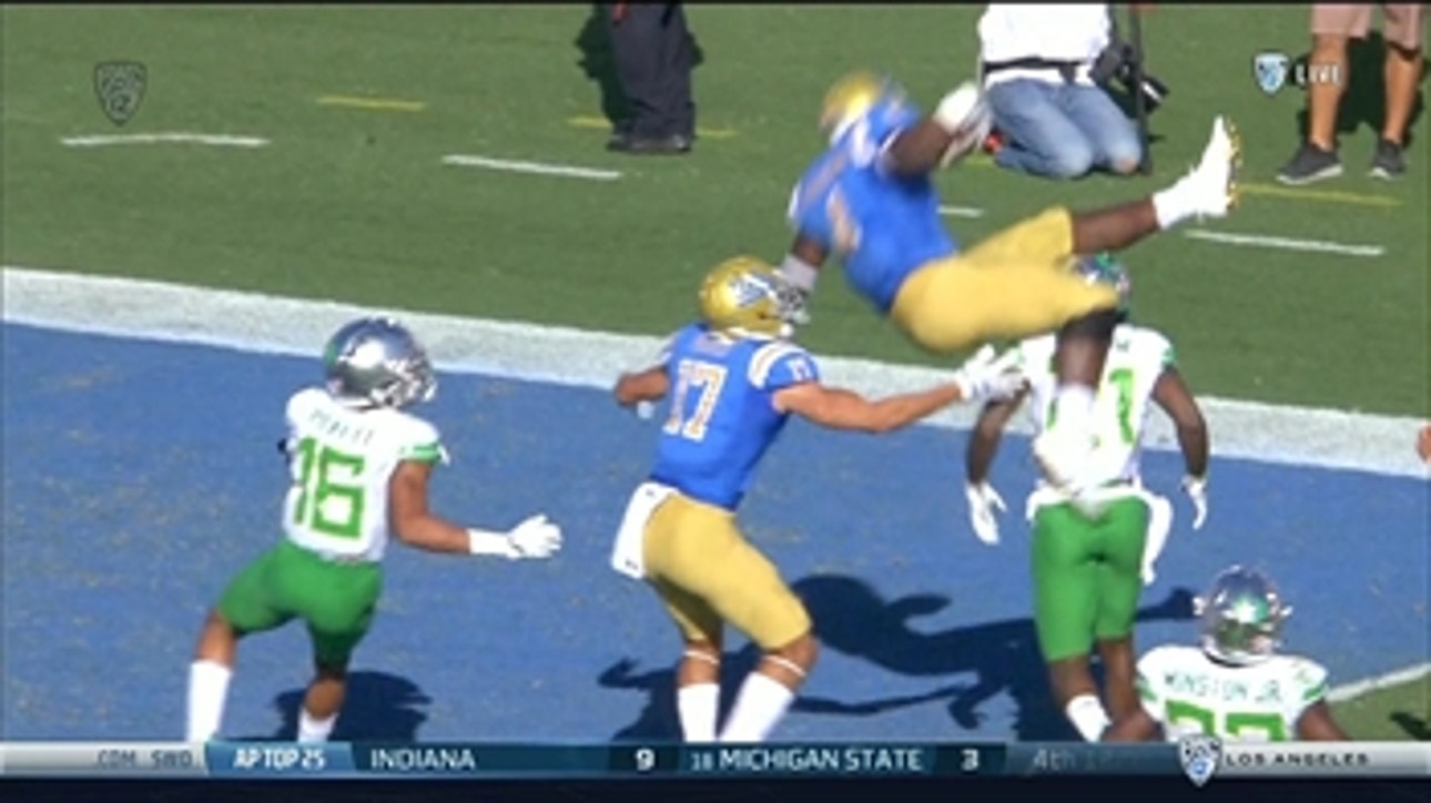 Watch UCLA's Bolu Olorunfunmi hurdle an Oregon defender on his way to the endzone