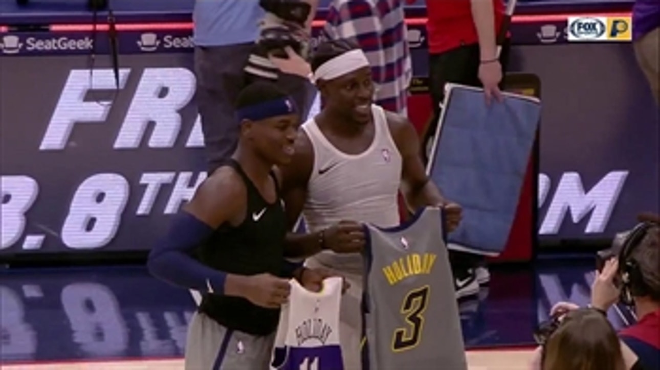 Aaron Holiday and brother Jrue Holiday exchange jerseys after game