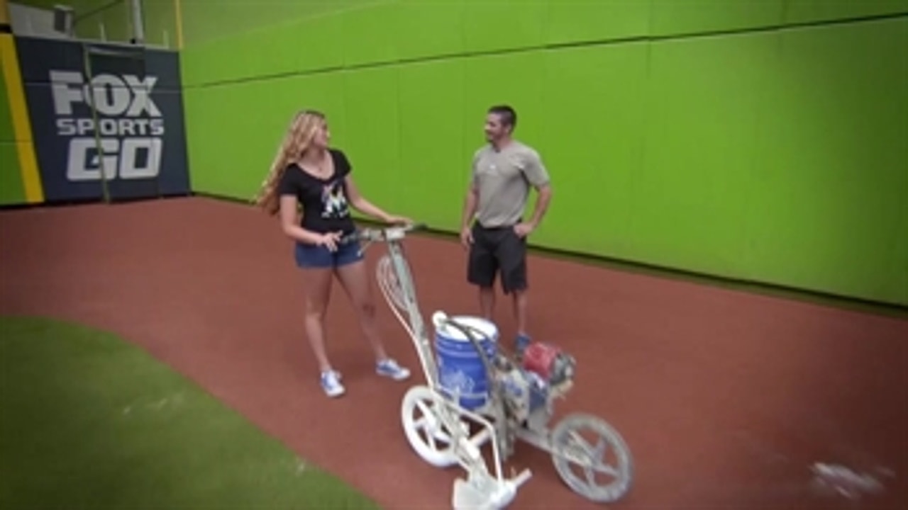 Taking the field: Kid reporter Josephine learns how to get the field ready with Marlins grounds crew