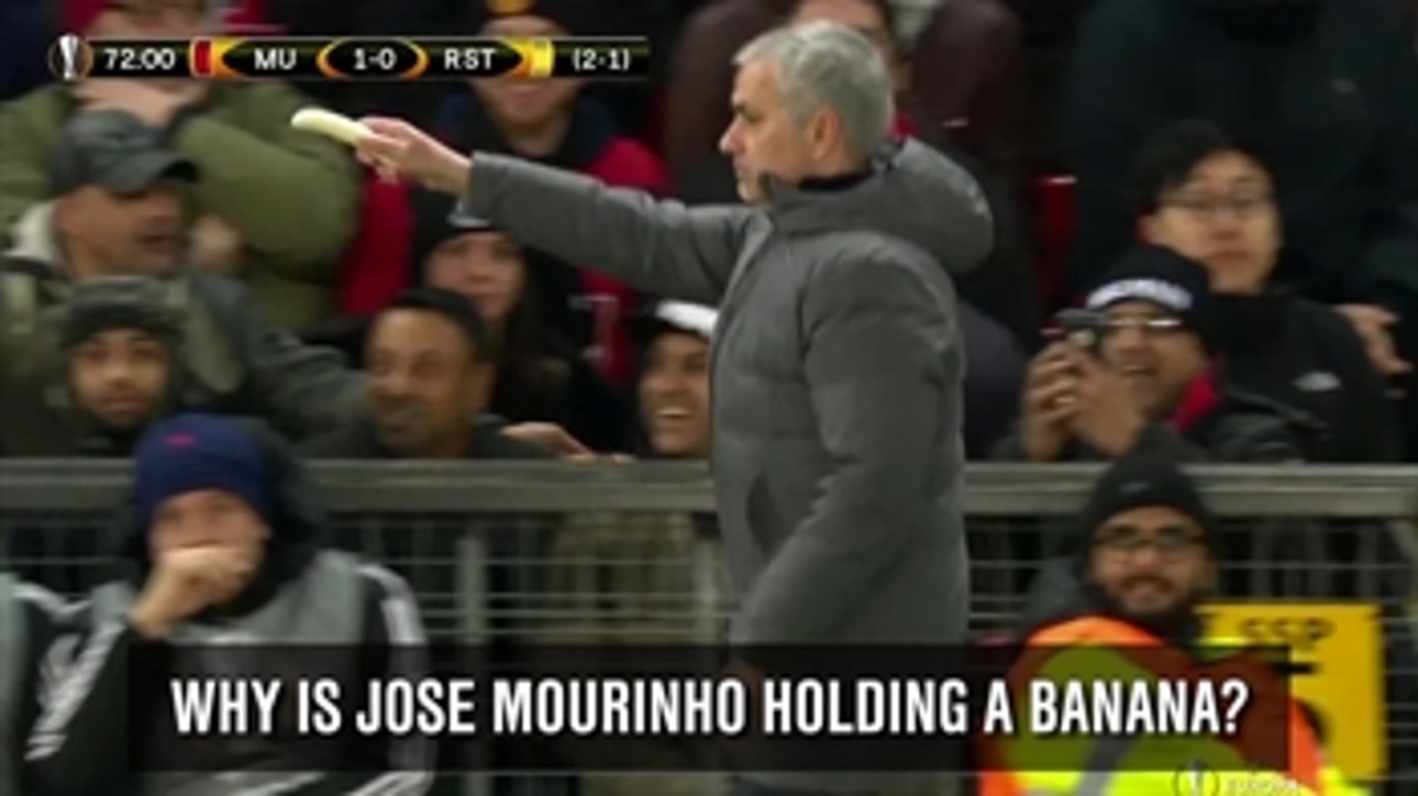 Jose Mourinho passes banana to Marcos Rojo during the game