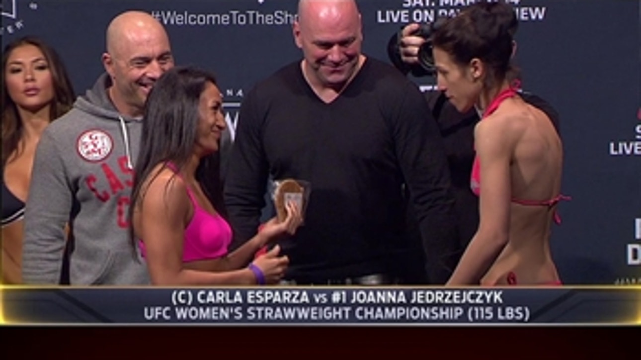 Jedrzejczyk hands Esparza a cookie during UFC 185 weigh-ins