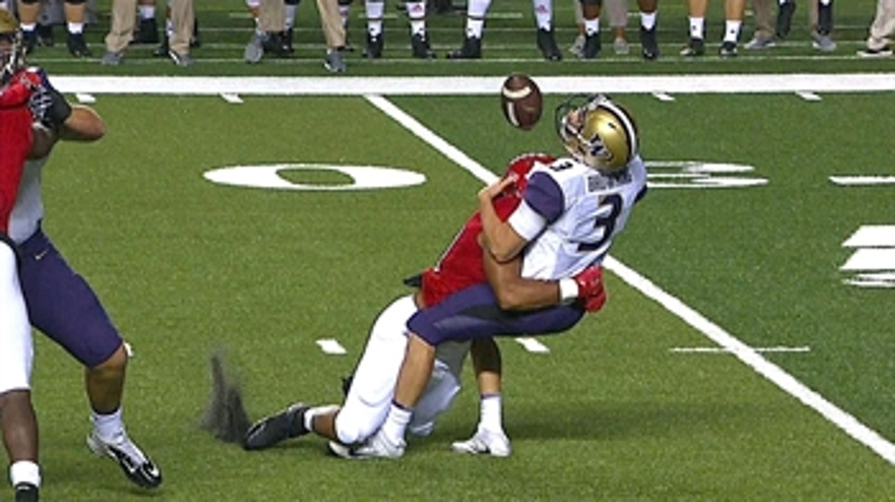 Washington's Jake Browning takes a big hit early for  a loss of 9 yards.