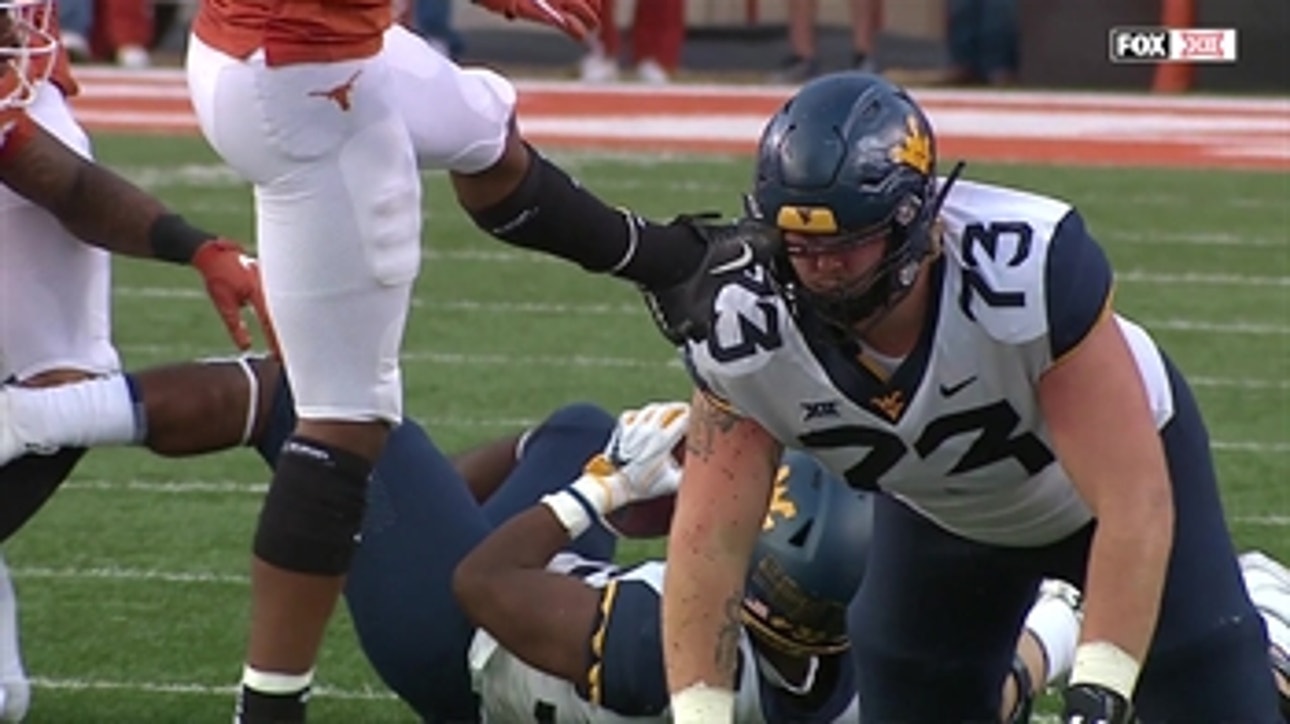 A Texas player got his shoe stuck in a West Virginia player's helmet, and it was hilarious