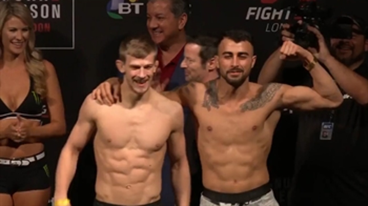 Two UFC fighters stage a fight at their weigh ins
