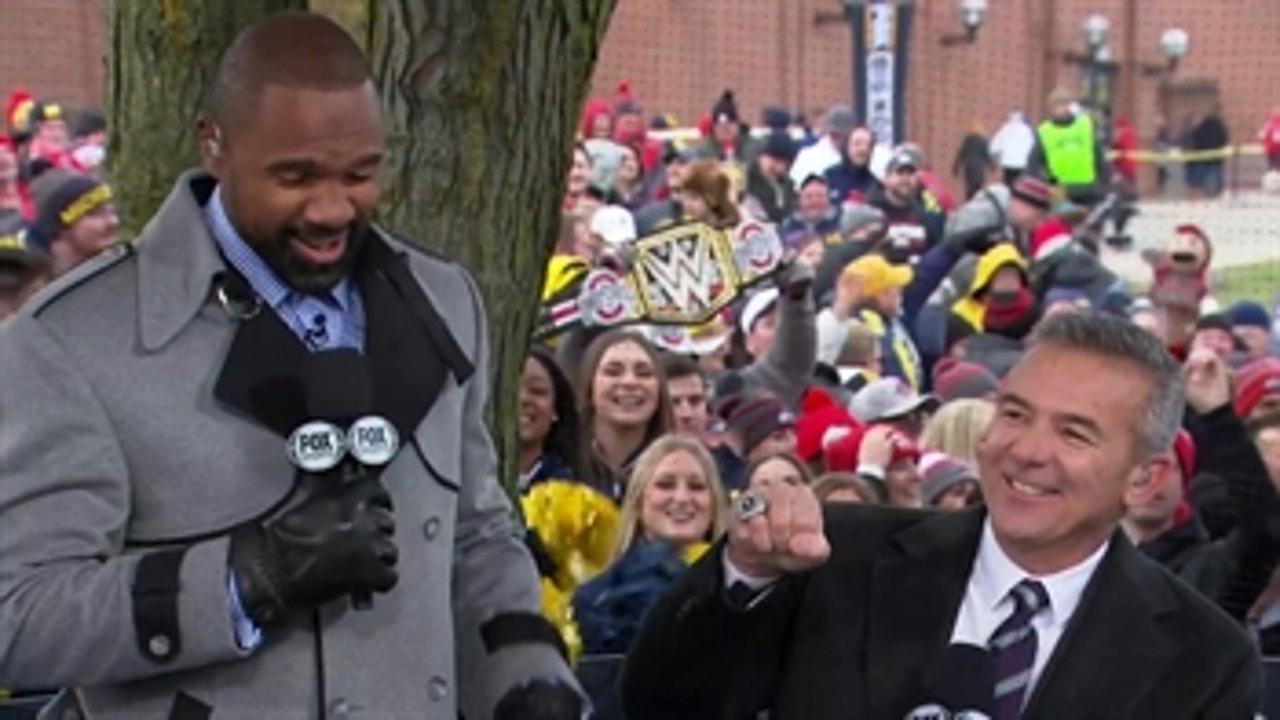 Urban Meyer gets hostile welcome from Michigan fans; Charles Woodson receives heroes welcome