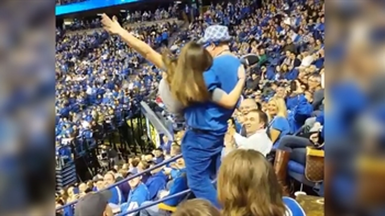 Watch a dancing Kentucky hoops fan crash down steps after scooping up a young woman