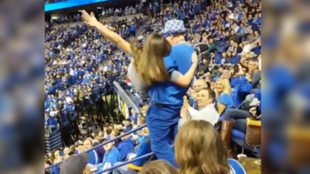 Watch a dancing Kentucky hoops fan crash down steps after scooping up a young woman