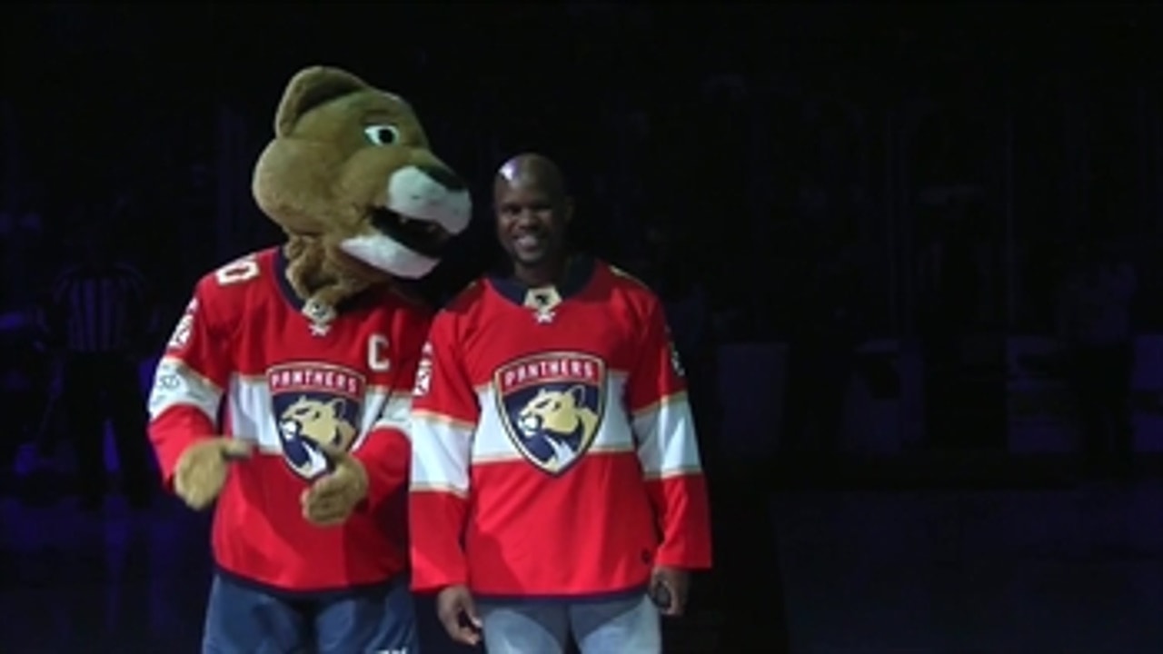 Miami Dolphins coach Brian Flores drops the puck before Panthers-Islanders