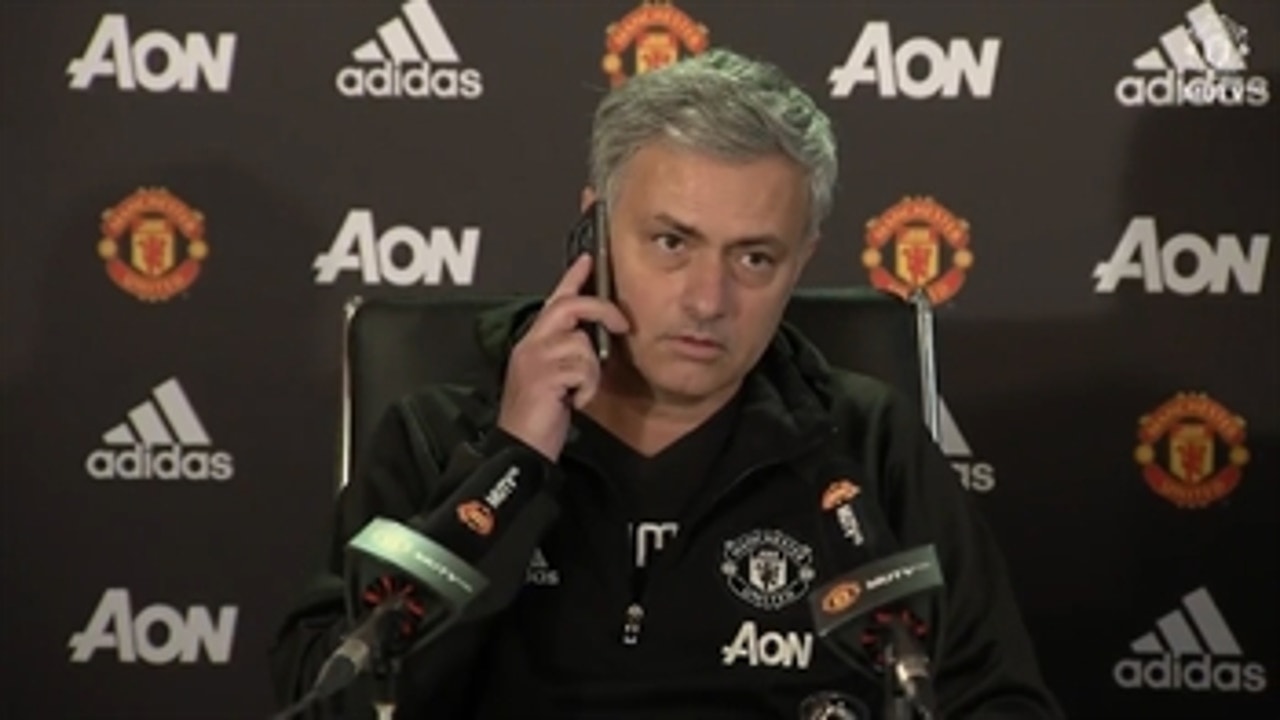 Jose Mourinho answers the phone during press conference