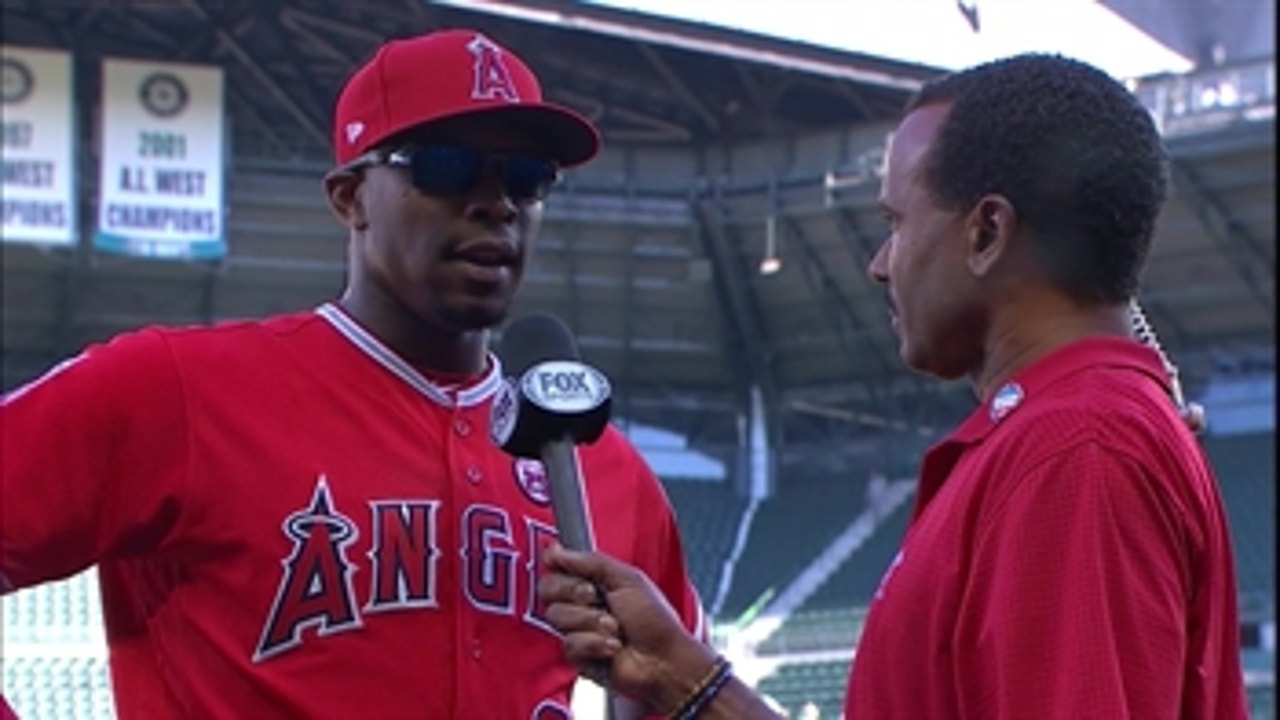 Justin Upton (1-for-4, 2 RBI) chats with Jose Mota after Angels beat Mariners
