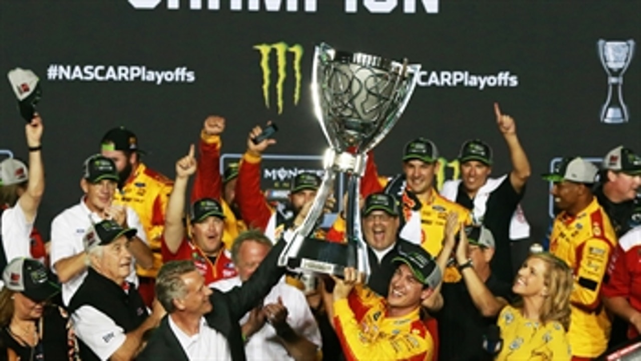 Steve Phelps presents Joey Logano with the Cup Series championship trophy