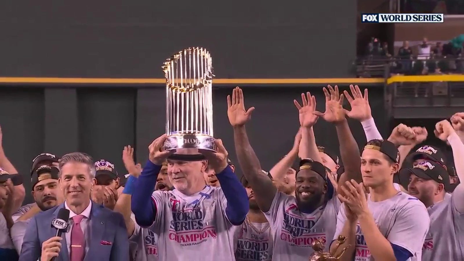 Manager Bruce Bochy lifts World Series trophy after Rangers win first title