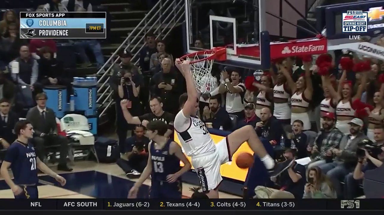 Donovan Clingan draws the foul on a monster two-handed jam to extend UConn's lead over Northern Arizona