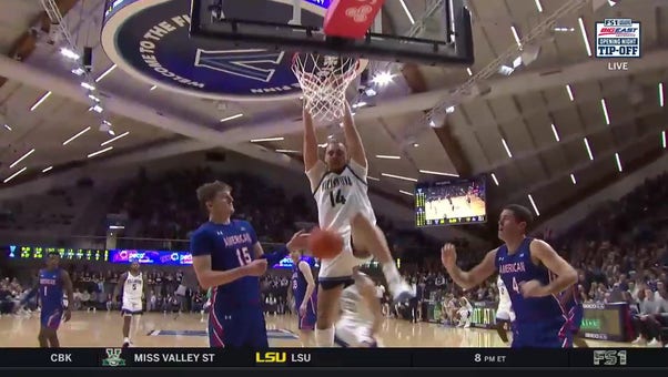 Lance Ware posts up in the paint and throws down the jam to extend Villanova's lead over American
