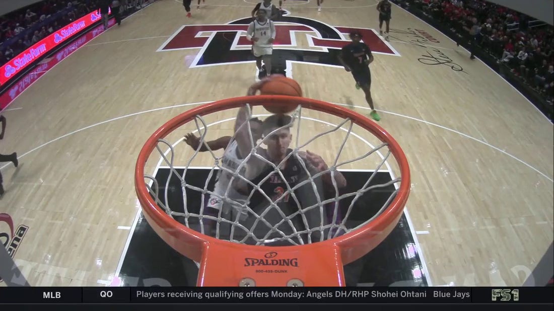 Cal State Fullerton's Grayson Carper throws down a dunk in transition against San Diego State
