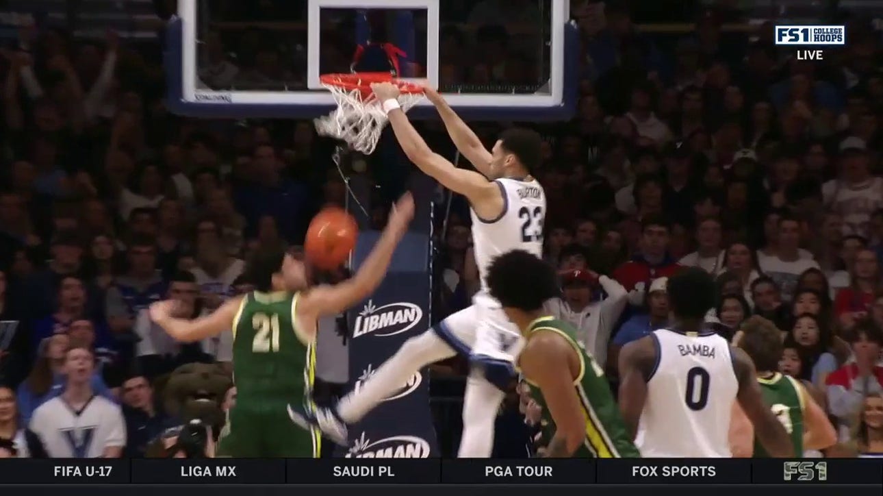 Villanova's Tyler Burton throws down a two-handed slam against Le Moyne