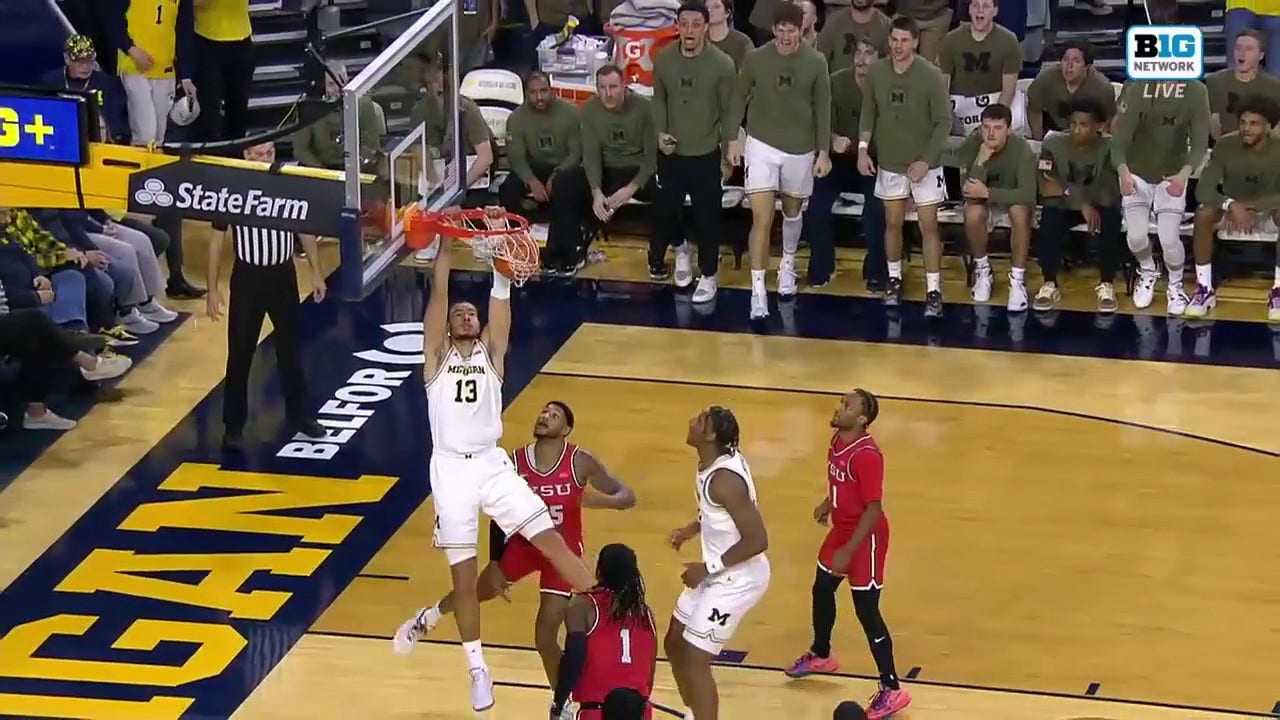 Olivier Nkamhoua drives inside for the two-handed jam, extending Michigan's lead over Youngstown State