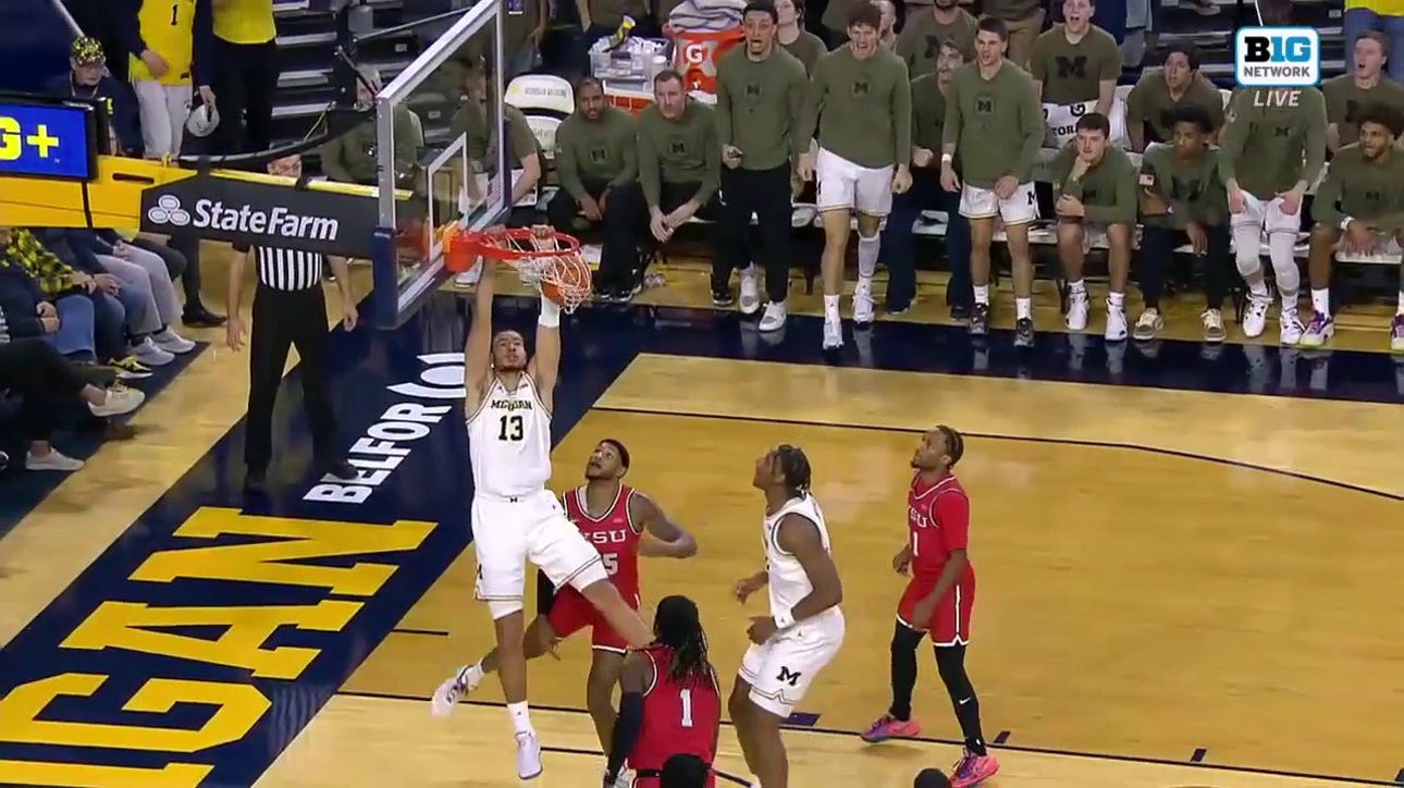 Olivier Nkamhoua drives inside for the two-handed jam, extending Michigan's lead over Youngstown State
