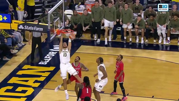 Olivier Nkamhoua drives inside for the two-handed jam, extending Michigan's lead over Youngstown State