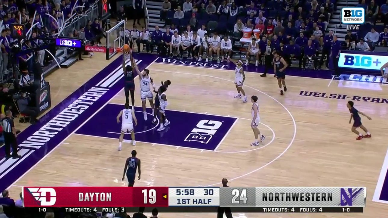 Dayton's DaRon Holmes II throws down the two-handed dunk to trim Northwestern's lead