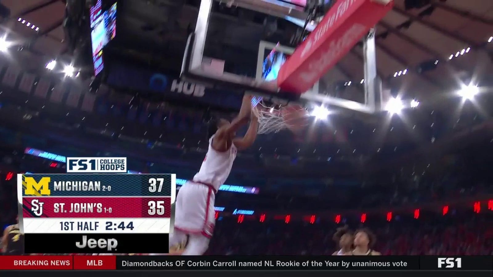 St. John's Jordan Dingle slams a two-handed dunk to trim Michigan's lead to two points